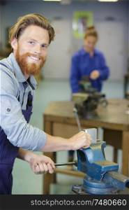 happy male worker working in workshop