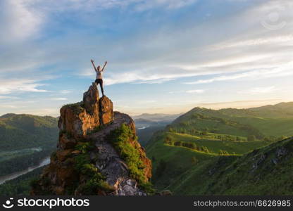 Happy man and woman on top mountain in Altai, sunset light, beauty summer landcape. Happy woman on top mountain