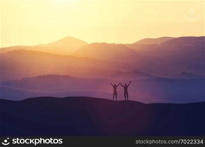 Happy man and woman standing on a hill, raising their hands. Winning and freedom concept. 3D illustration.. Happy man and woman standing on a hill