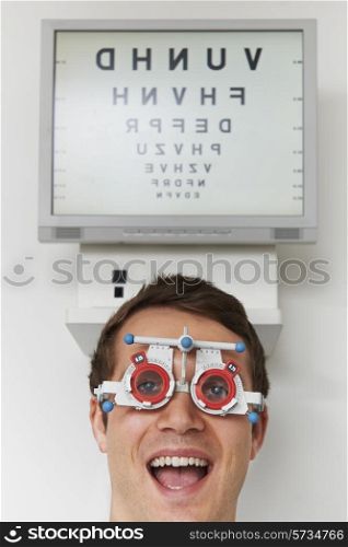 Happy Man At Optometrist Having Sight Test