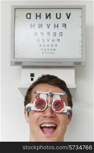 Happy Man At Optometrist Having Sight Test