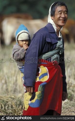 Happy Man Carrying Baby