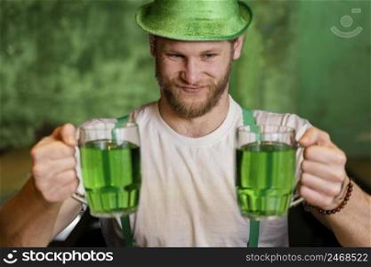 happy man celebrating st patrick s day with drinks