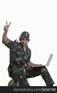 Happy man celebrating success while using laptop
