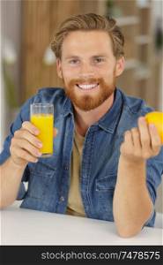 happy man drinking orange juice