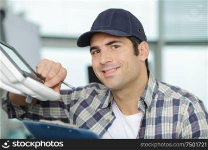 happy man fixing a printer