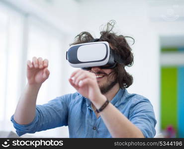 happy man getting experience using VR-headset glasses of virtual reality at home