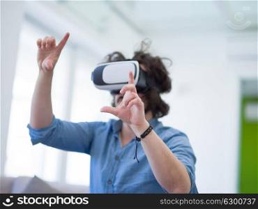 happy man getting experience using VR-headset glasses of virtual reality at home