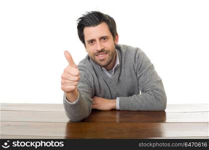 happy man going thumb up, on a desk, isolated. happy man