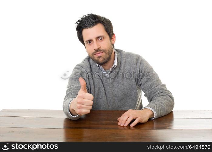 happy man going thumb up, on a desk with a tablet pc, isolated. happy man