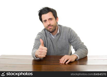 happy man going thumb up, on a desk with a tablet pc, isolated. happy man