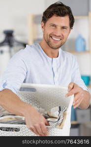 happy man holding a basket at home