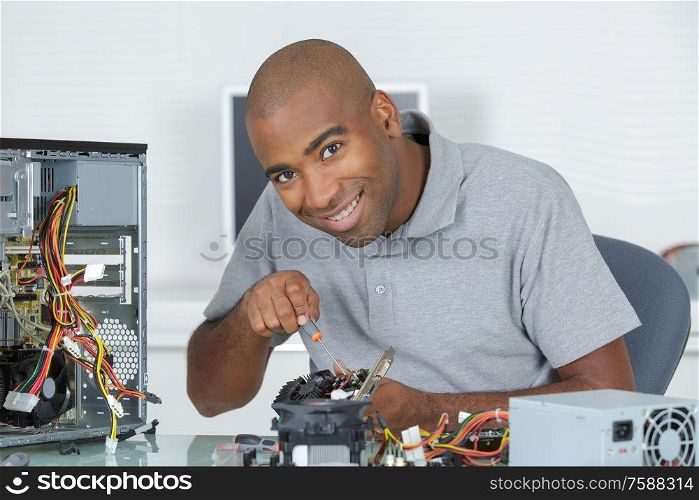 happy man is fixing a motherboard