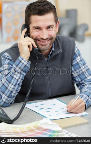 happy man on telephone working in his office