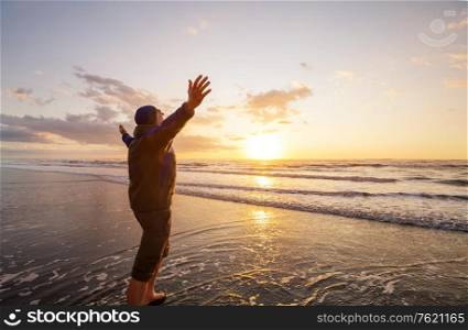 Happy Man on the sunset ocean beach