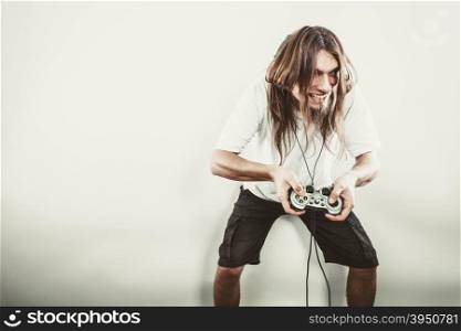 Happy man playing games. Playing games. Young smiling cheerful man play on console xbox playstation. Guy with pad joystick.