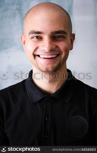 Happy man portrait. Portrait of young adult happy man against grunge wall