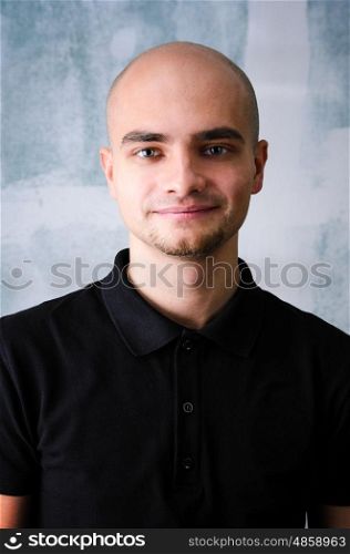 Happy man portrait. Portrait of young adult happy man agaist grunge wall