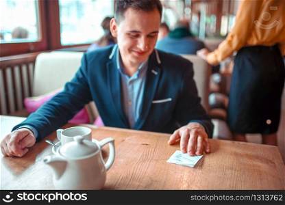 Happy man read love note with a phone number. Attractive romantic proposal