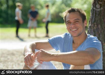 happy man sitting on green grass