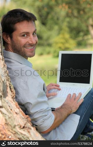Happy man sitting outdoors