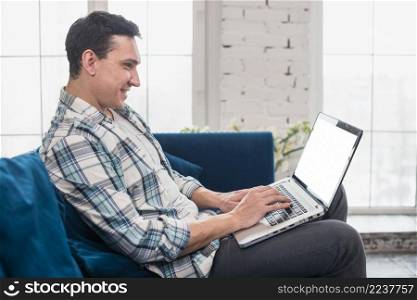 happy man sitting using laptop