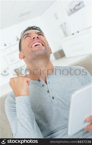 happy man using digital tablet