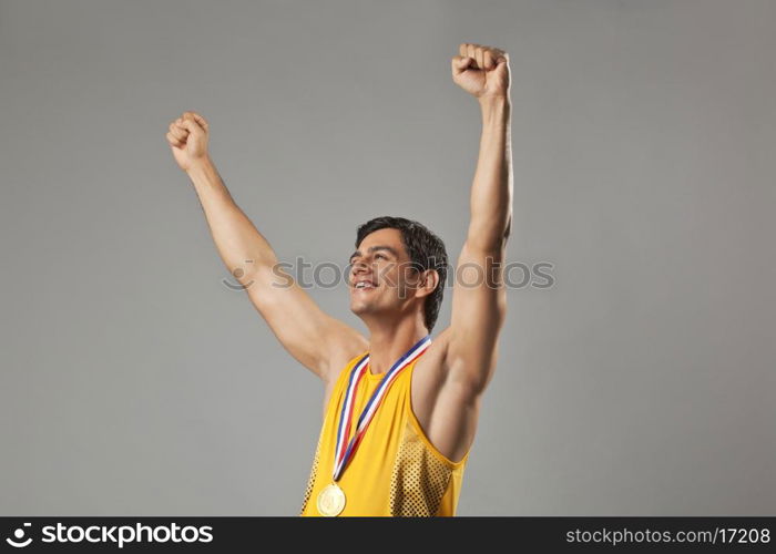 Happy man with arms raised celebrating victory isolated over white background