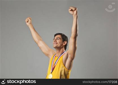 Happy man with arms raised celebrating victory isolated over white background