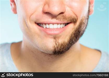 Happy man with half shaved face beard hair.. Closeup of happy man with half shaved face beard hair. Smiling guy on blue. Skin care and hygiene.