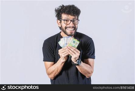 Happy man with money in hand, joyful man with bills in hand, concept of man with money isolated