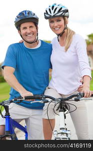 Happy Man & Woman Couple Riding Bikes