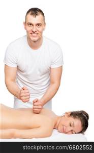 Happy massage therapist and the patient relax on a massage table