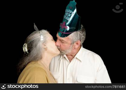 Happy mature couple exchanging a passionate New Years kiss. Isolated on black.