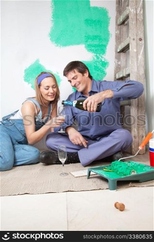 Happy mature couple having champagne at their new apartment