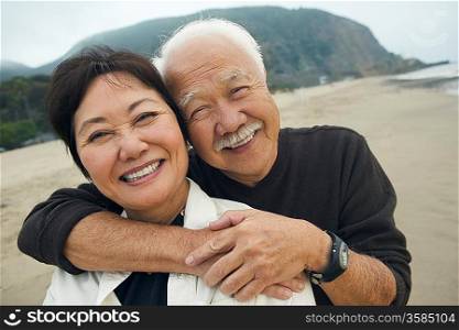Happy Mature Couple Hugging on Beach