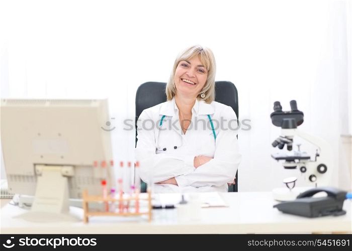 Happy mature doctor woman at office