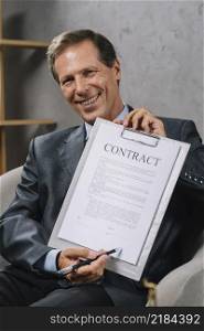 happy mature lawyer pointing signature place contract document with pen