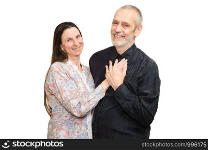 Happy mature man and woman with long hair smiling for S. Valentine's day or anniversary and putting the hands on the heart. Isolated on white background.