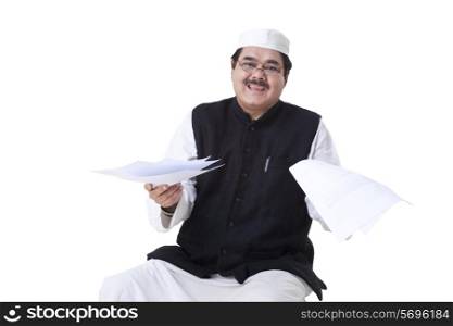 Happy mature politician holding documents