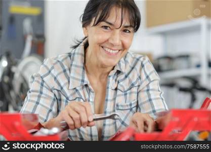 happy mature woman working a garage
