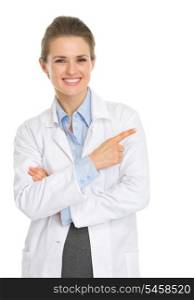 Happy medical doctor woman pointing on copy space