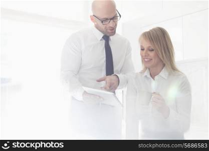 Happy mid adult business couple using tablet PC at home