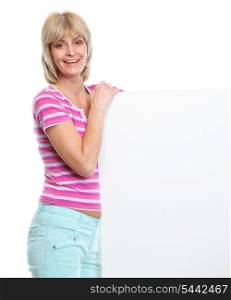 Happy middle age woman holding blank billboard