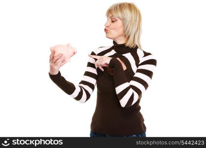 Happy middle age woman pointing on piggy bank