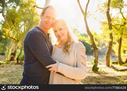 Happy Middle Aged Caucasian Couple Portrait Outdoors.