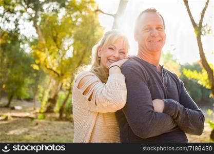 Happy Middle Aged Caucasian Couple Portrait Outdoors.