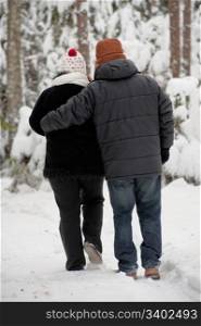 Happy middle-aged couple walking on a winter day