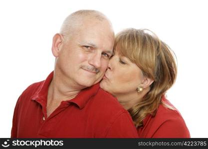 Happy middle aged man receiving a kiss from his wife. Isolated on white.