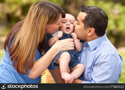 Happy Mixed Race Parents Playing with Their Giggling Son.